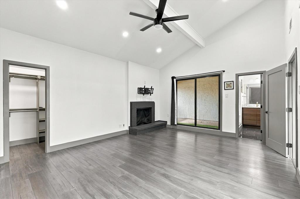 Primary bedroom with fireplace and private balcony patio