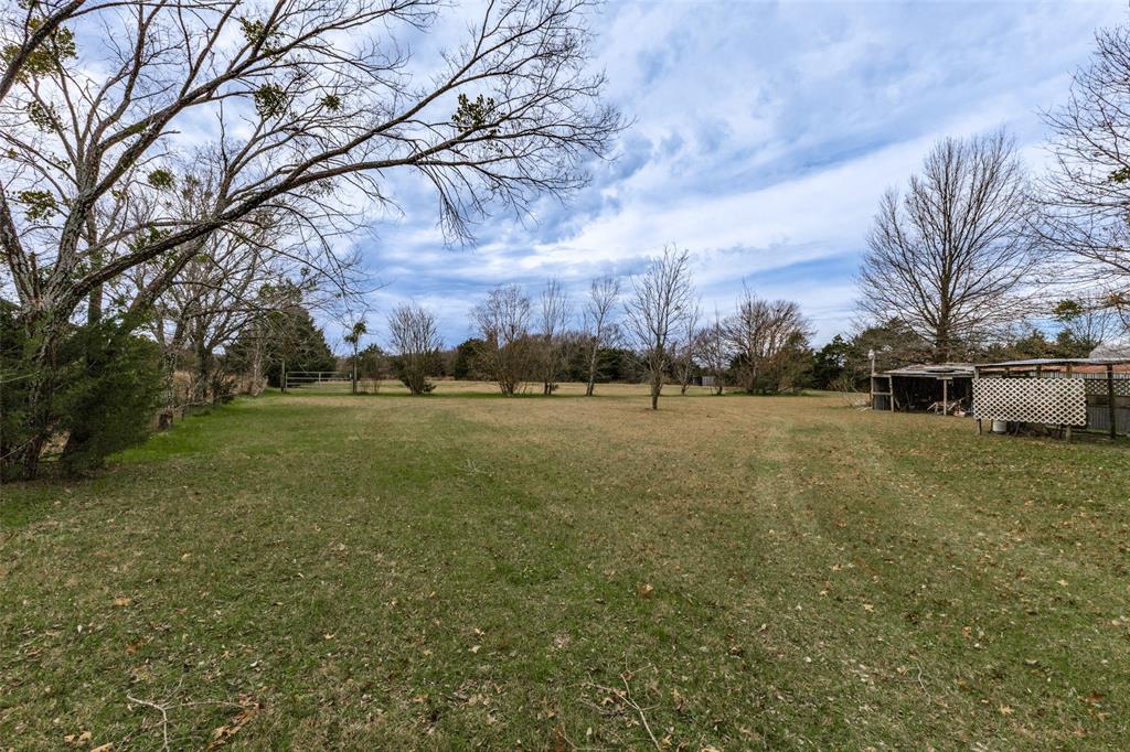 Large open area, surrounded by trees, located at back of property Large open area, surrounded by trees, located at back of property