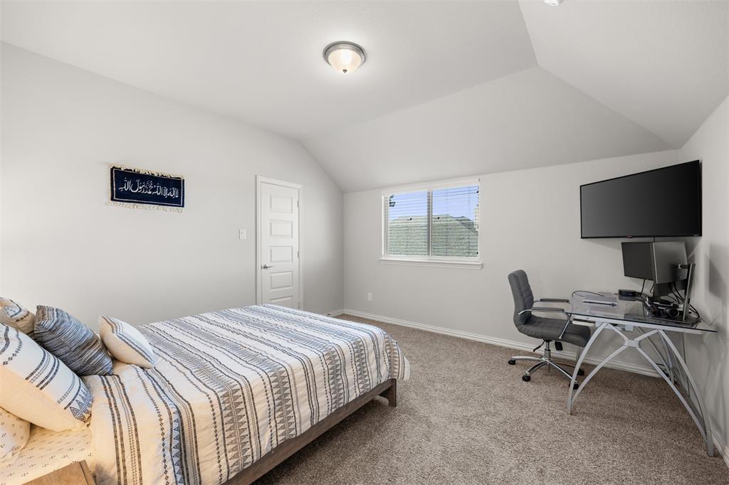 Vaulted ceilings, neutral wall color, wall-to-wall carpeting, single-hung window, and two-panel interior door