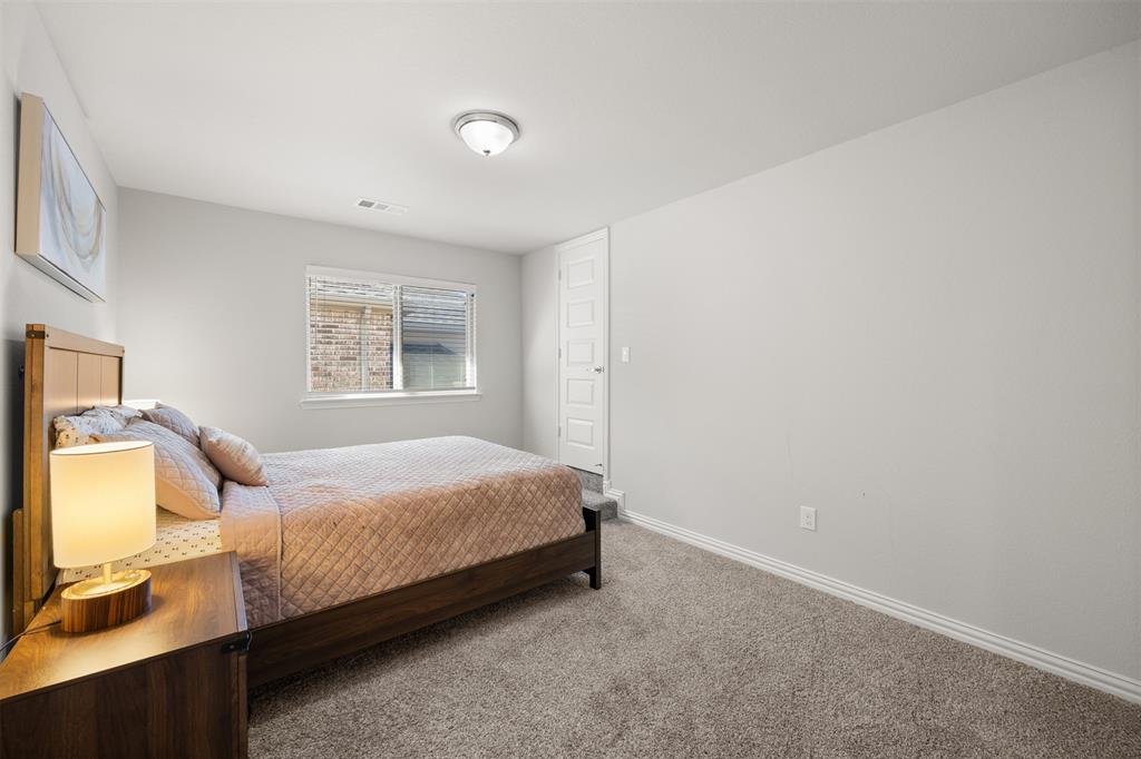 Neutral-toned interior room featuring wall-to-wall carpeting, a single-hung window, and a multi-panel door