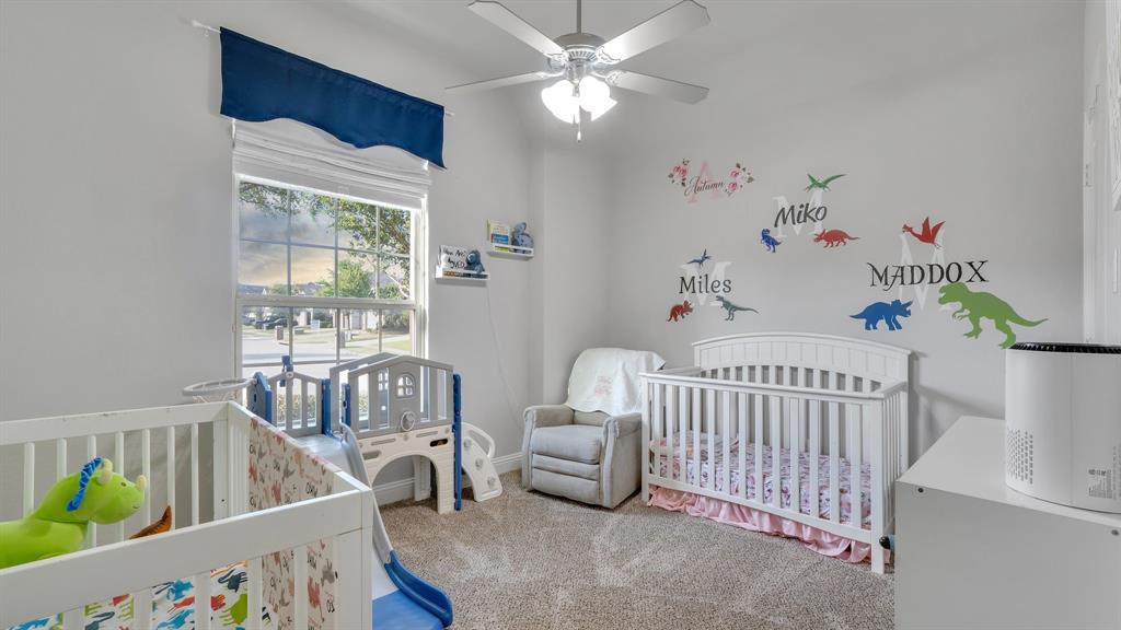 Bedroom featuring neutral wall paint, carpeted flooring, a vaulted ceiling with a central multi-blade ceiling fan, and a grid-pattern window
