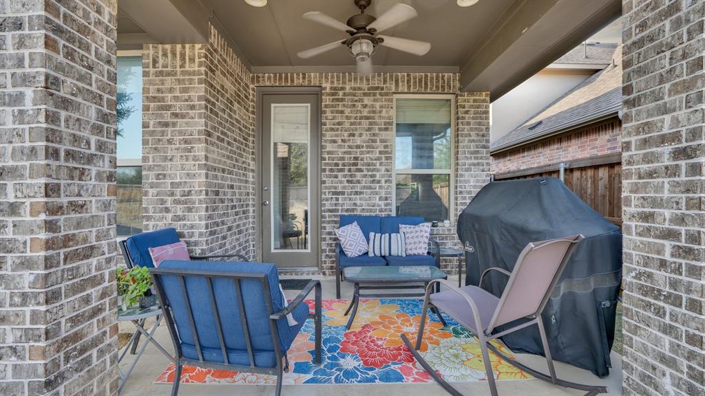 Covered patio featuring brick masonry columns, recessed lighting, and a ceiling-mounted fan