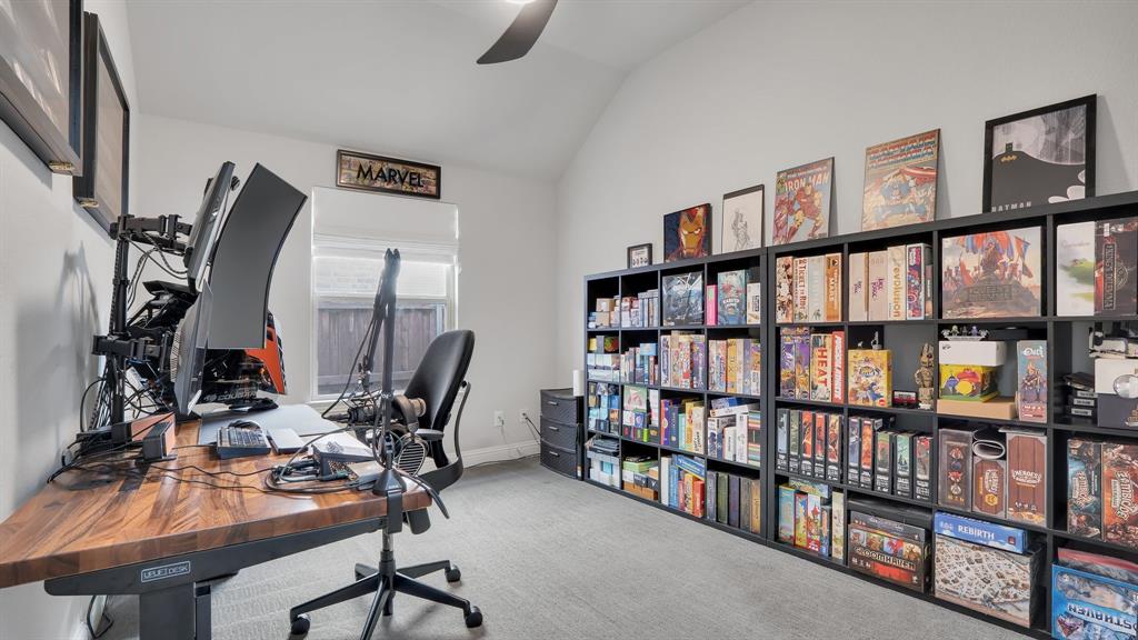 Vaulted ceiling, carpeted flooring, and a single window with a roller shade