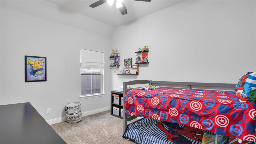Room featuring high ceilings, neutral wall tones, carpeted flooring, a ceiling fan, and a single-pane window