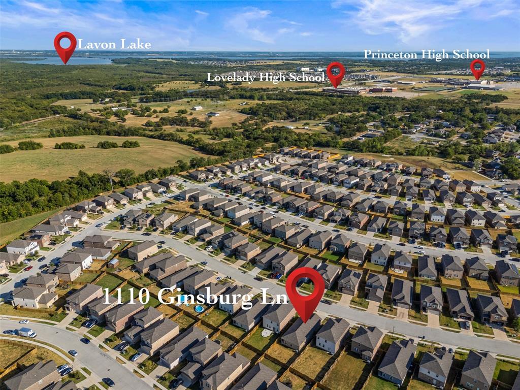Aerial perspective of a residential development featuring single-family dwellings, paved thoroughfares, and proximity to open acreage