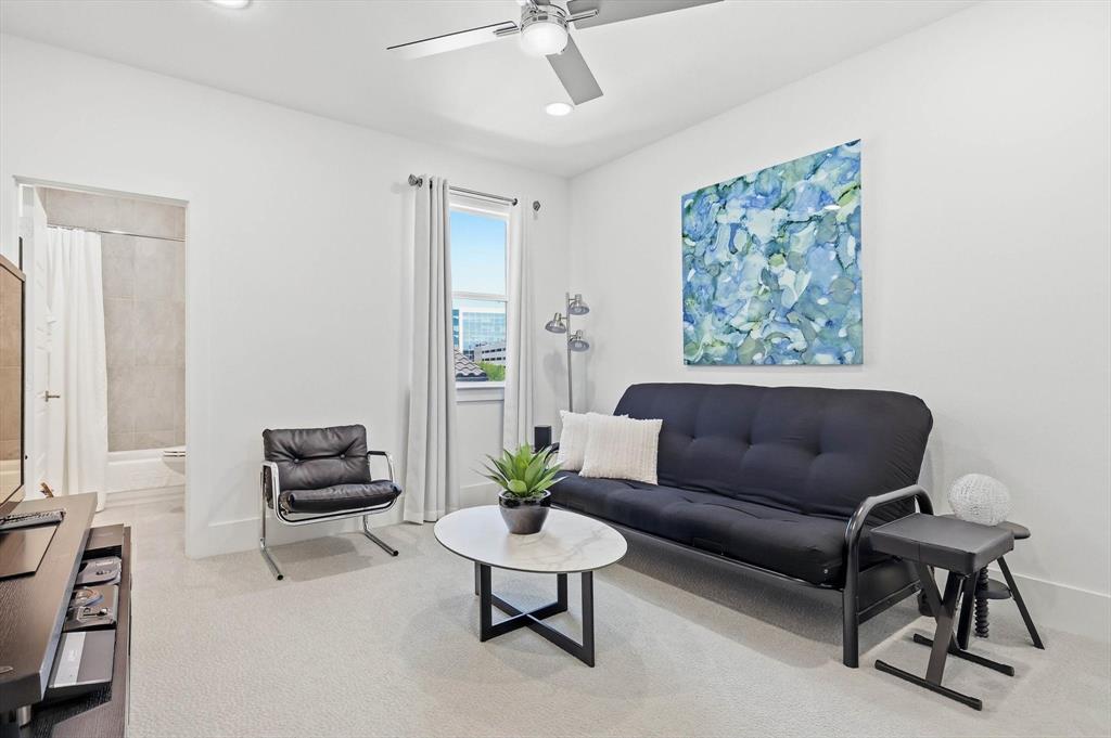 Room featuring neutral wall-to-wall carpeting, a ceiling fan with integrated lighting, and a single vertical window