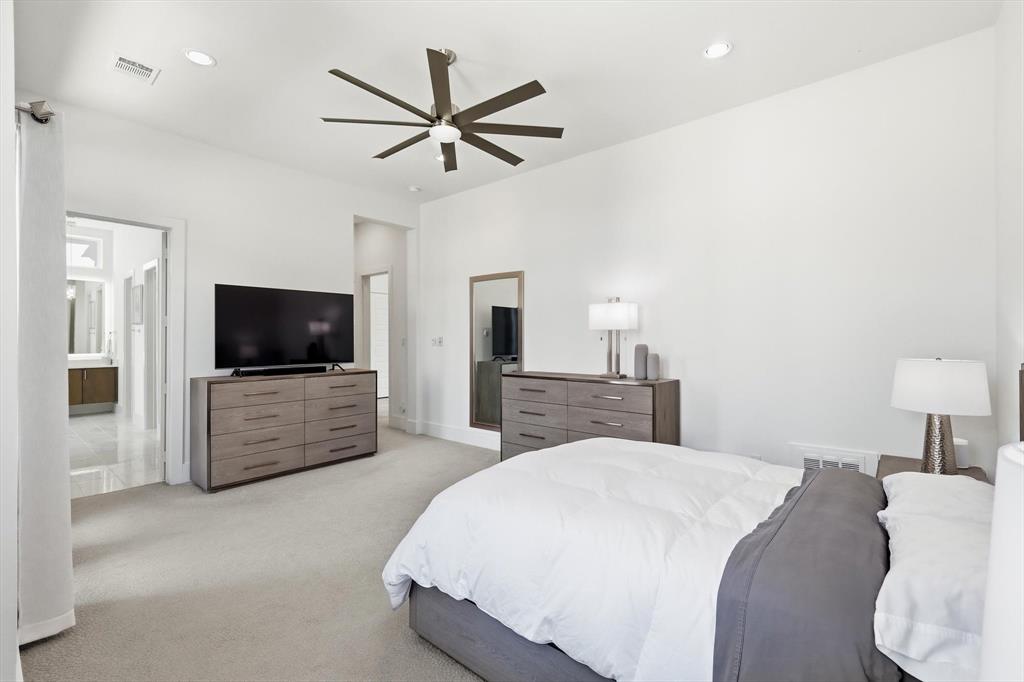 Spacious interior featuring high ceilings, neutral wall-to-wall carpeting, recessed lighting, and a multi-blade ceiling fan with integrated light fixture