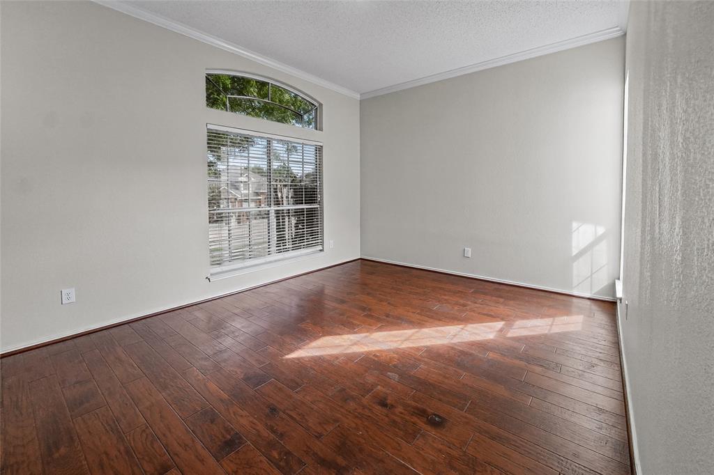 Wood-finish flooring, vaulted ceilings, and an arched transom window