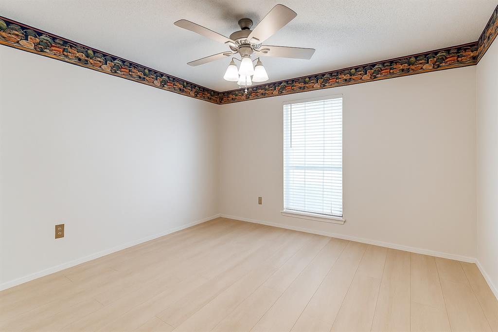 Bedroom with ceiling fan, light wood-type flooring, and baseboards
