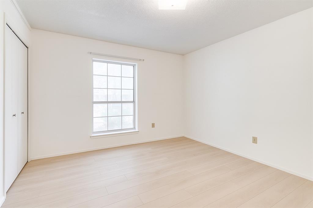 Unfurnished bedroom with multiple windows, light wood-style flooring, a closet, and baseboards