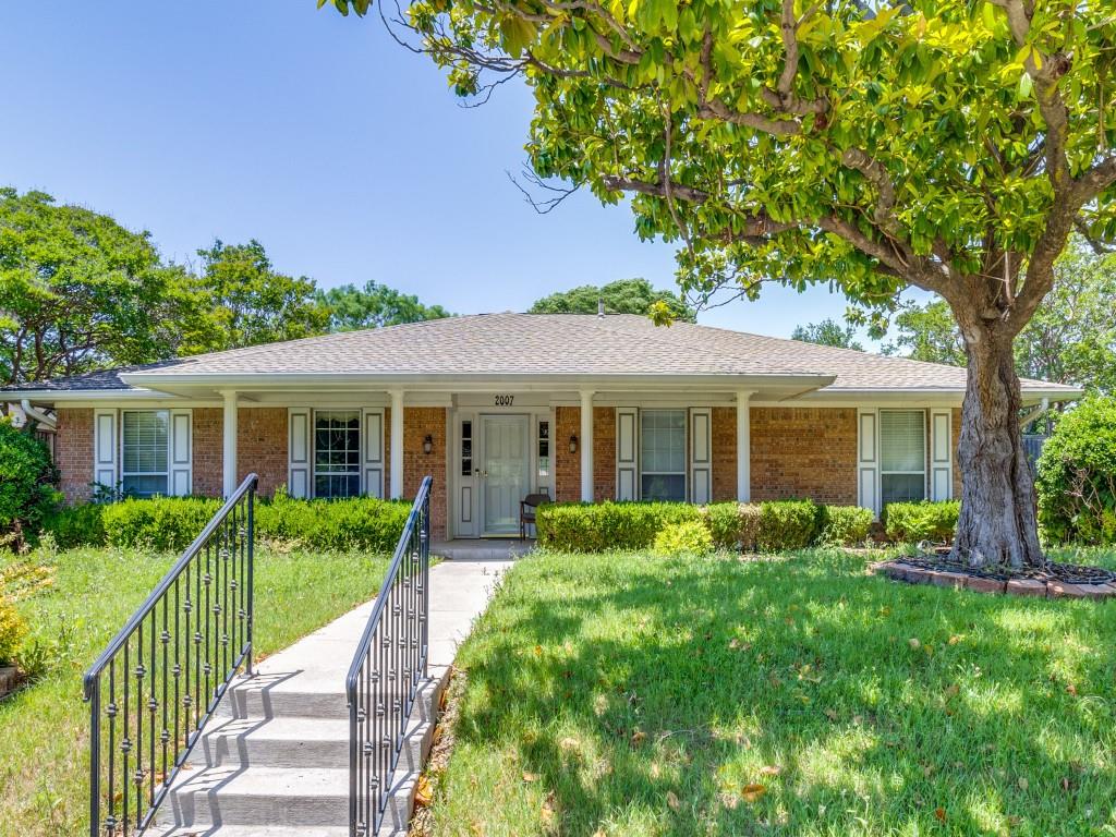 Single story home with a porch, brick siding, and a front yard