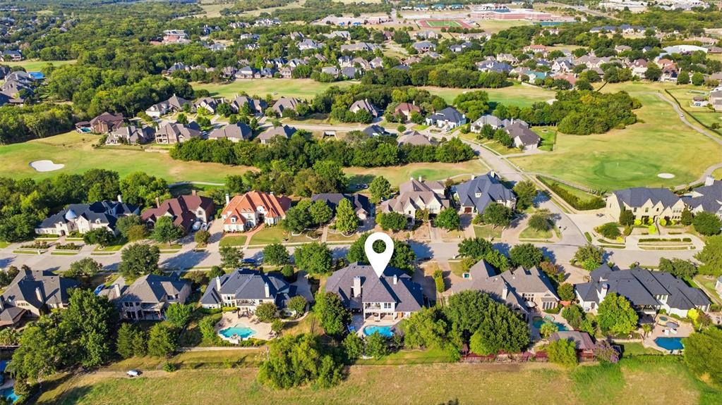 Expansive residential neighborhood with mature trees, green spaces, and multiple properties featuring private swimming pools