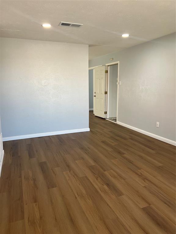 Interior space featuring wood-finish flooring, neutral wall paint, and recessed lighting Interior space featuring wood-finish flooring, neutral wall paint, and recessed lighting