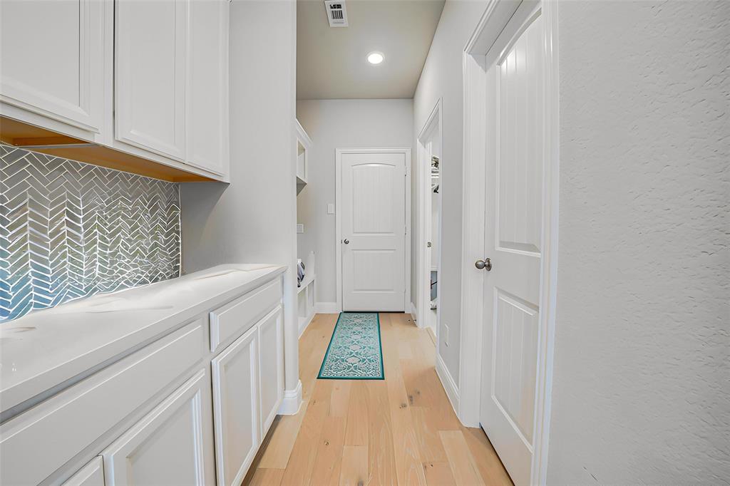 Hall featuring light wood-type flooring and recessed lighting