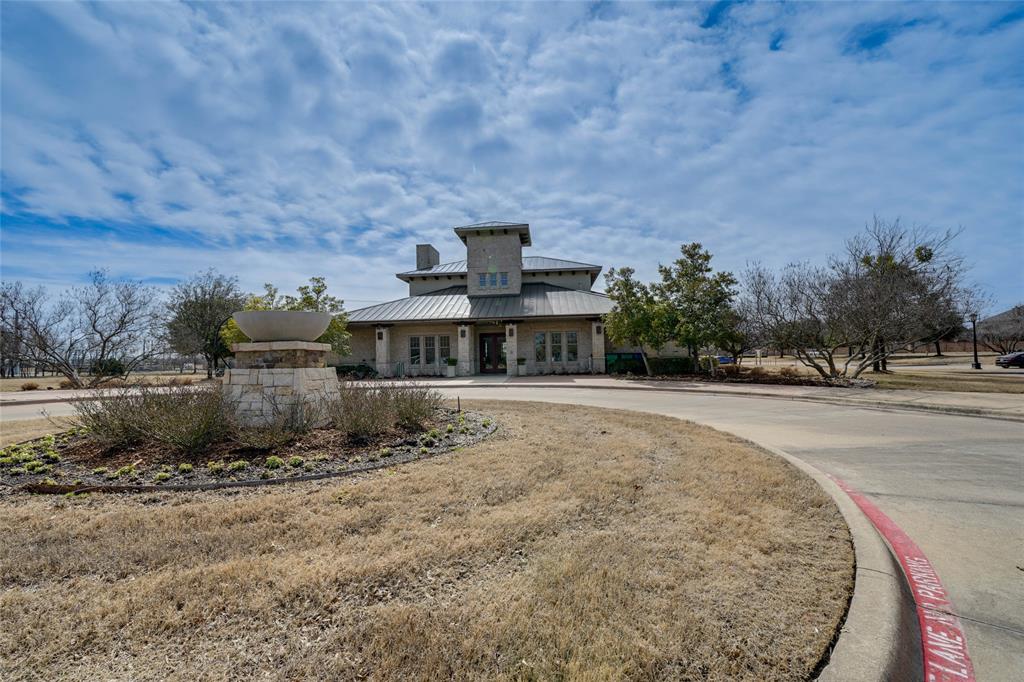 View of front of house with a metal roof, french doors, a standing seam roof, and curved driveway