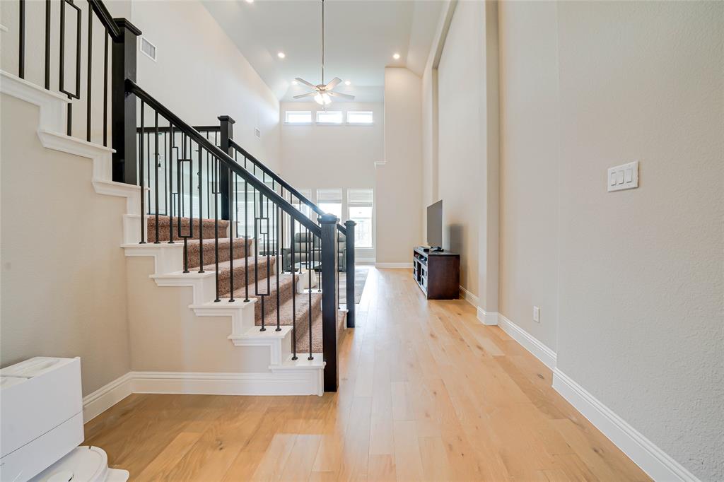 Entrance foyer with light wood-style floors, a ceiling fan, recessed lighting, a towering ceiling, and stairway