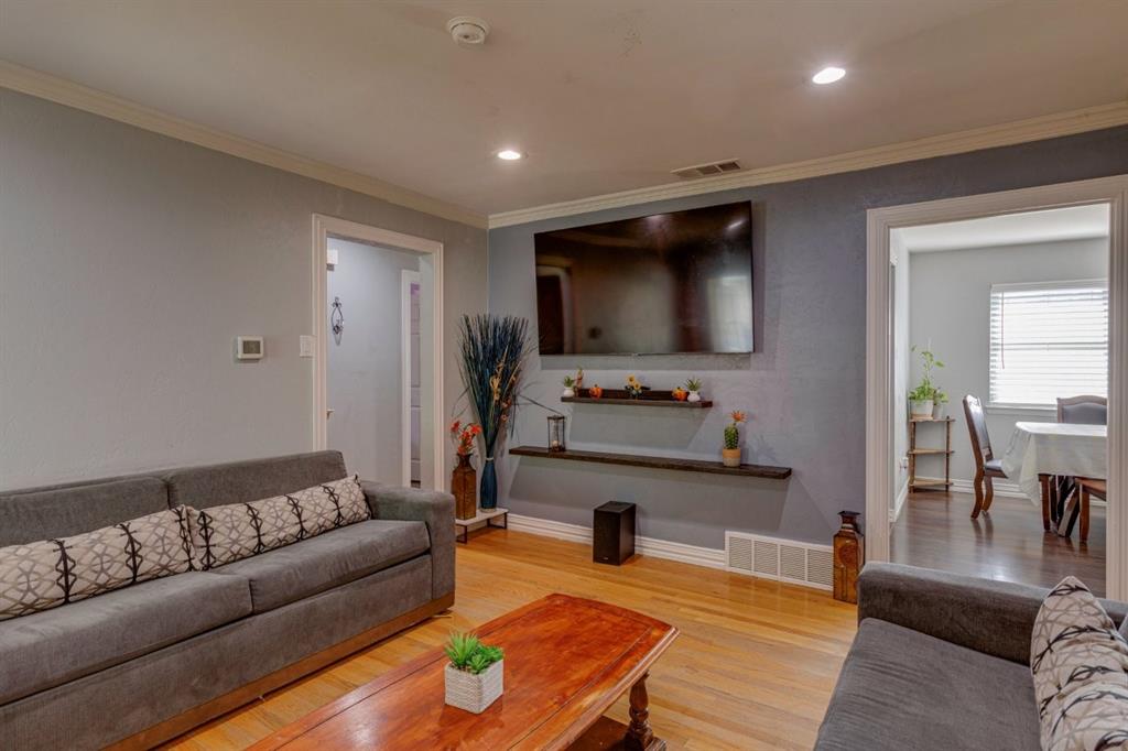 Wood-finish flooring, recessed lighting, and wall-mounted shelving