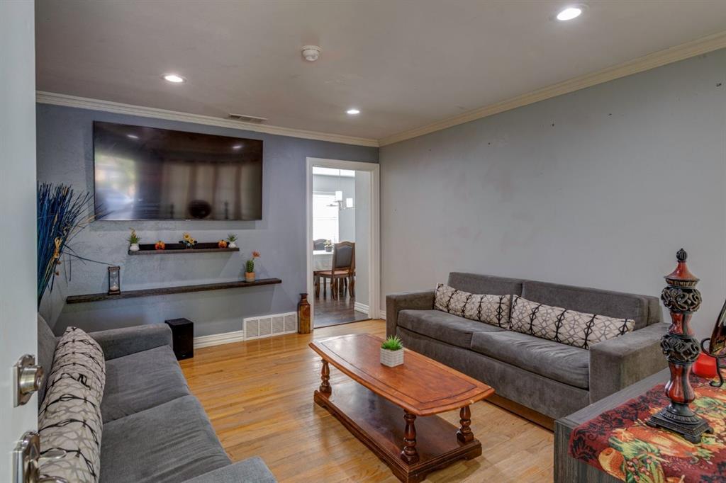 Hardwood flooring, recessed lighting, crown molding, and tiered wall-mounted shelving