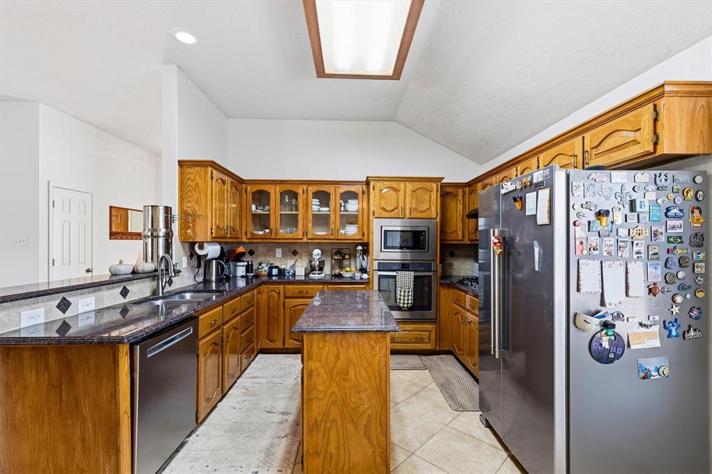 Kitchen features SS built in stacked microwave and oven and drop in gas range and sichwasher