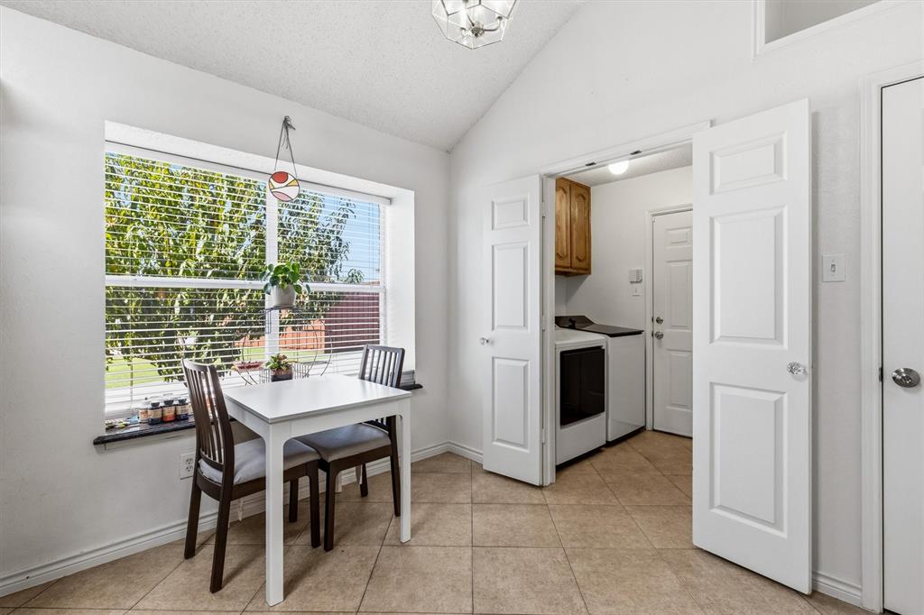 The eat in kitchen breakfast area with picture window overlooking the backyard. Entry tot he garage is through the utility room