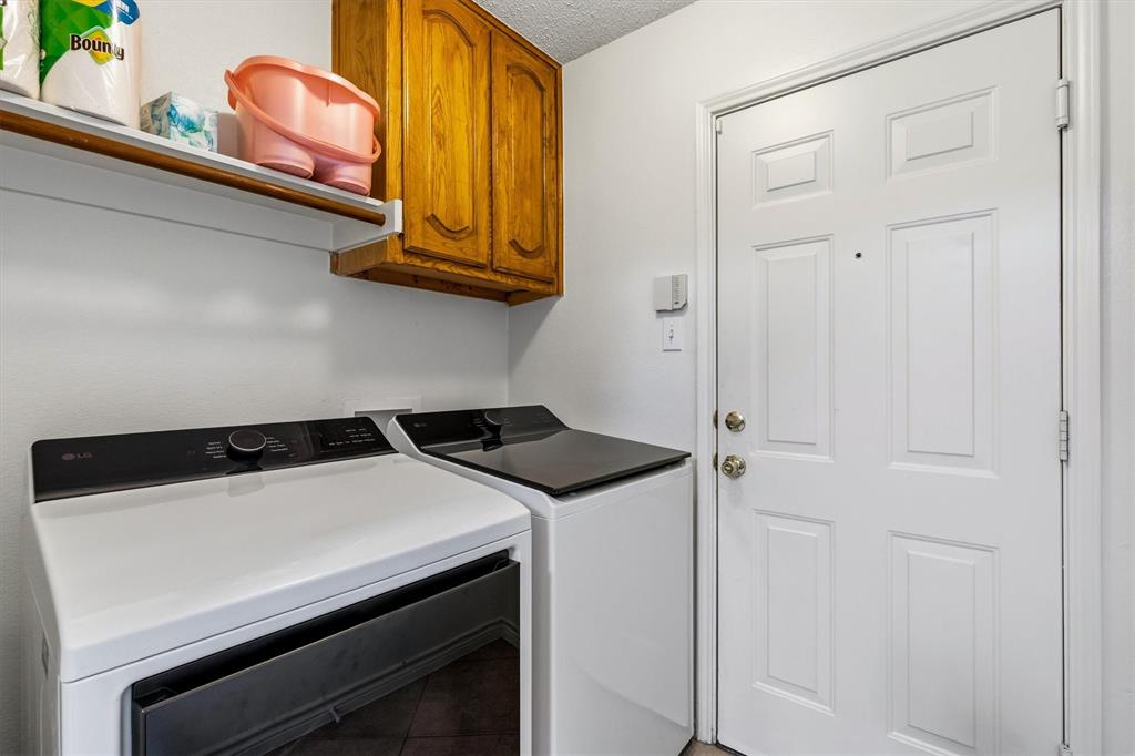 the utility room with built in cabinet and FS WD connections and access to the garage