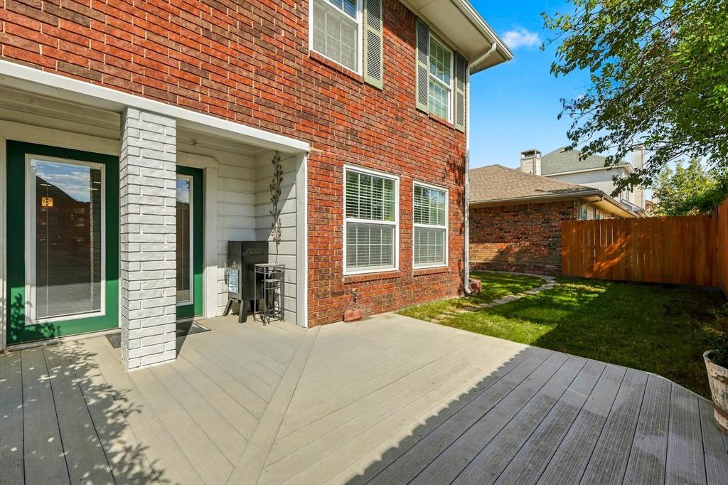 Backyard offers a composite deck and six foot tall fence.