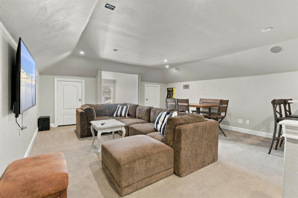 Vaulted ceilings with recessed lighting, carpeted flooring, and multi-panel interior doors