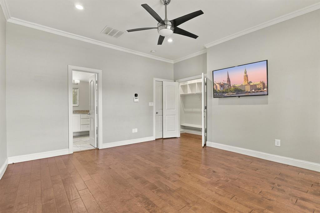 Wood-finish flooring, brushed metal ceiling fan with integrated lighting, recessed lighting, and built-in closet shelving