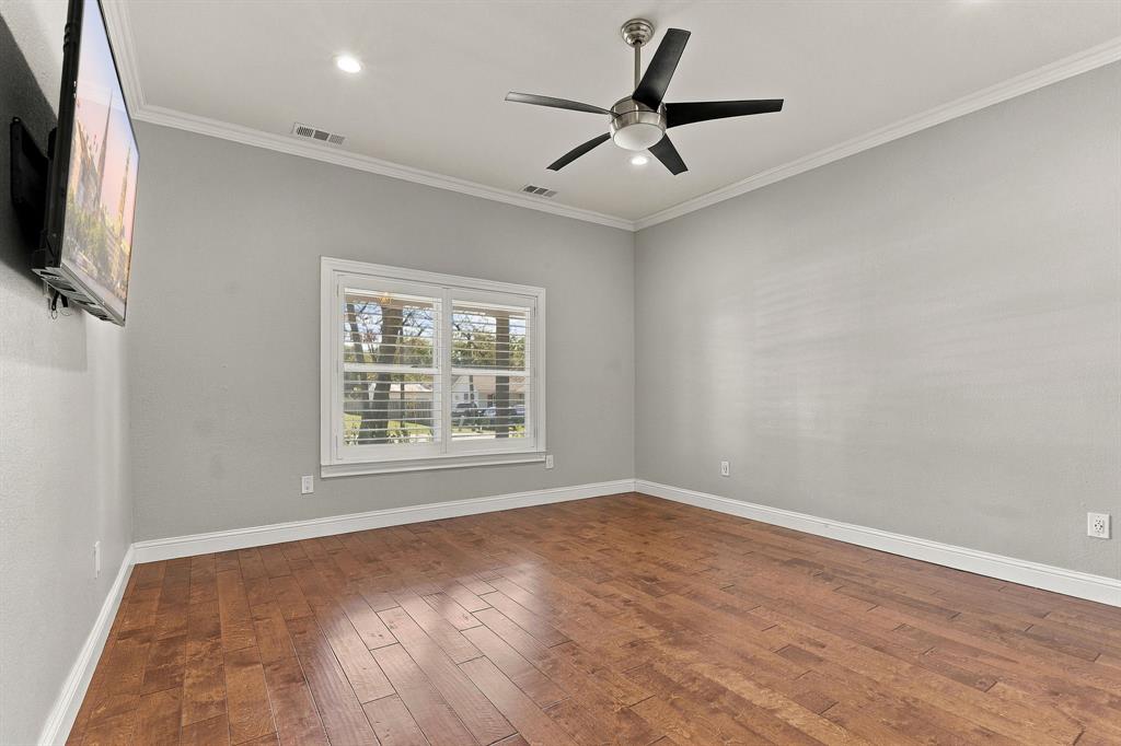Room featuring wood-finish flooring, crown molding, recessed lighting, a modern ceiling fan, and window plantation shutters