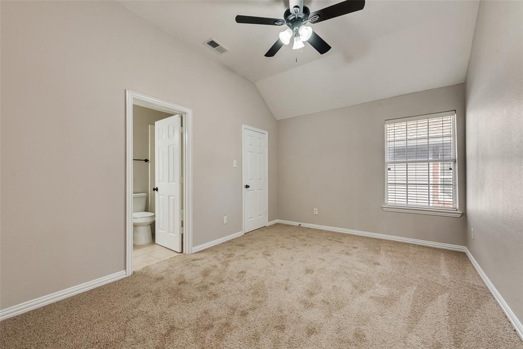 Vaulted ceilings, neutral carpeting, multi-light ceiling fan, and multi-panel interior doors
