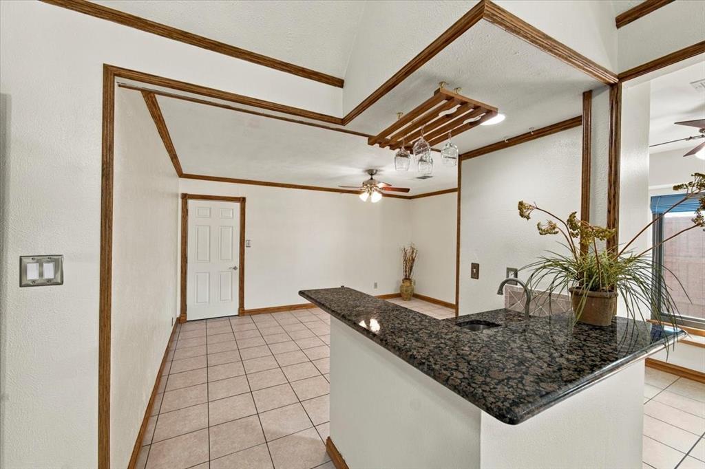 Wet bar with granite counter top = kitchen to the right and door to the garage - all walls painted 10/26 Wet bar with granite counter top = kitchen to the right and door to the garage - all walls painted 10/26