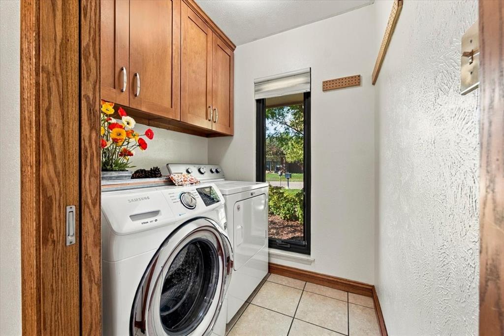 Pocket doors - off kitchen - washer and dryer remain with the home - window to the front yard - more custom cabinets