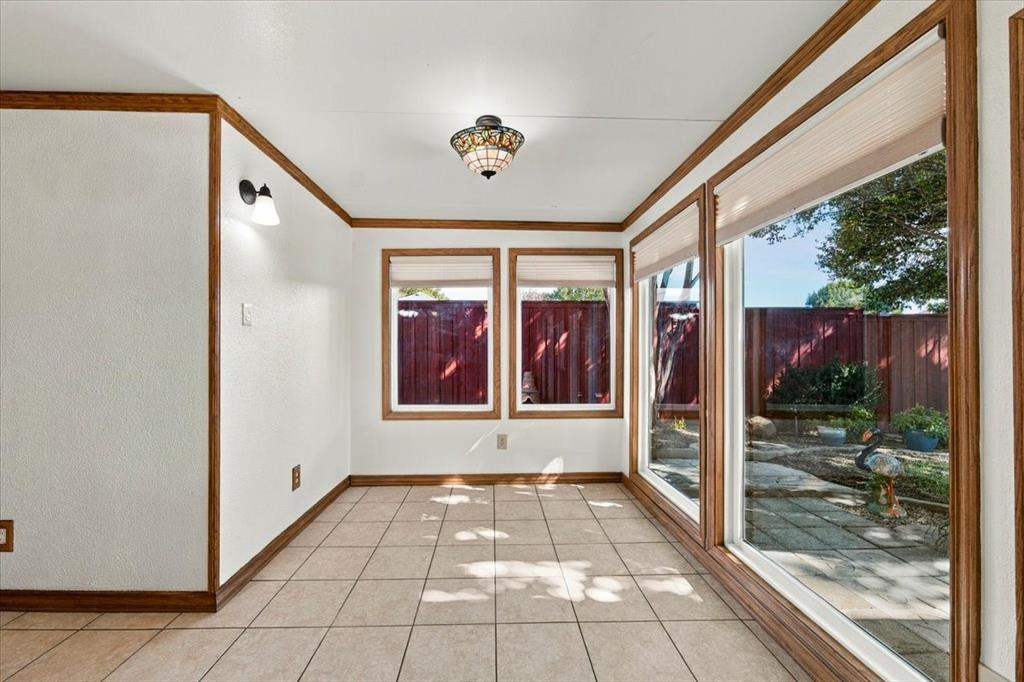 This is the east corner of the sunroom - lots of decorative lighting and great views to the back yard, courtyard
