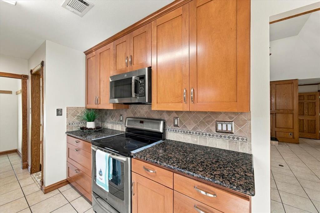 Induction electric range, cabinets galore, all stainless appliances - GE microwave