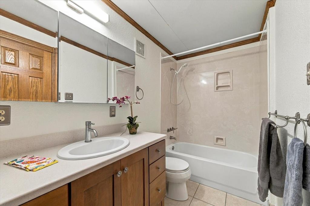 Full bath off the sunroom - granite counter tops - beautiful mirror has hidden medicine cabinet - no grout lines in the tub enclosure