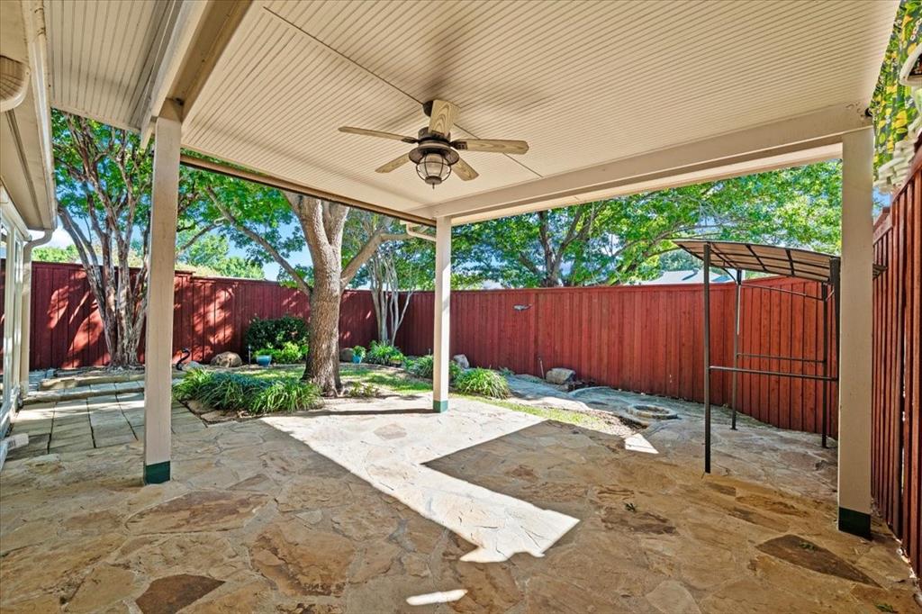 Covered patio- flagstone walkways throughout the garden - year around perennials landscaping - additional covered area for relaxation  - all of this is viewed from the sunroom