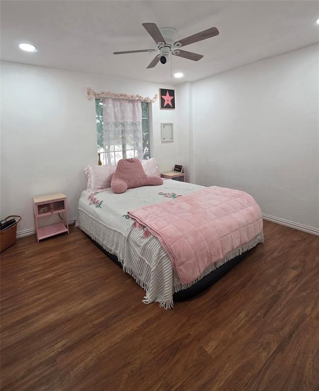 Room featuring wood-finish flooring, recessed lighting, and a central ceiling fan