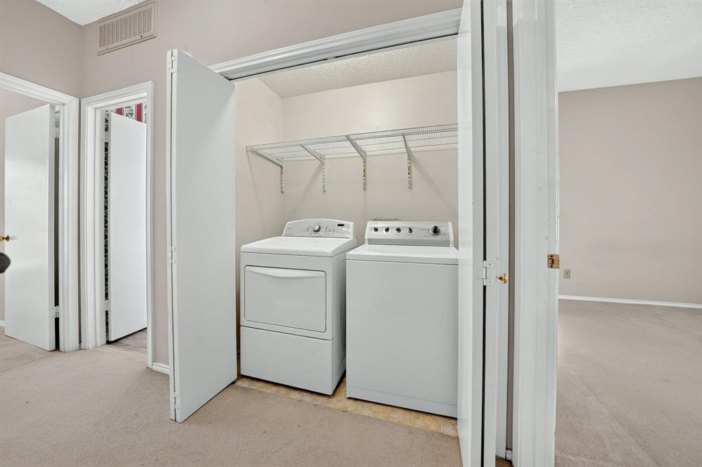 Laundry closet featuring bifold doors and integrated overhead wire shelving