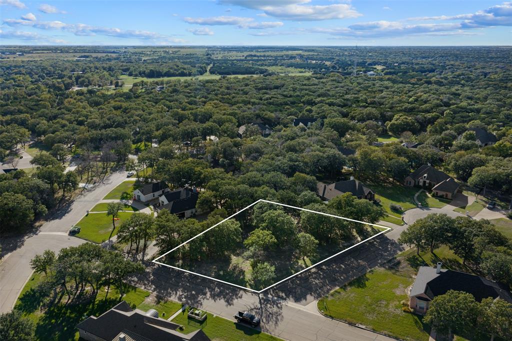Corner lot featuring mature hardwood trees and established residential infrastructure with approximate boundaries marked