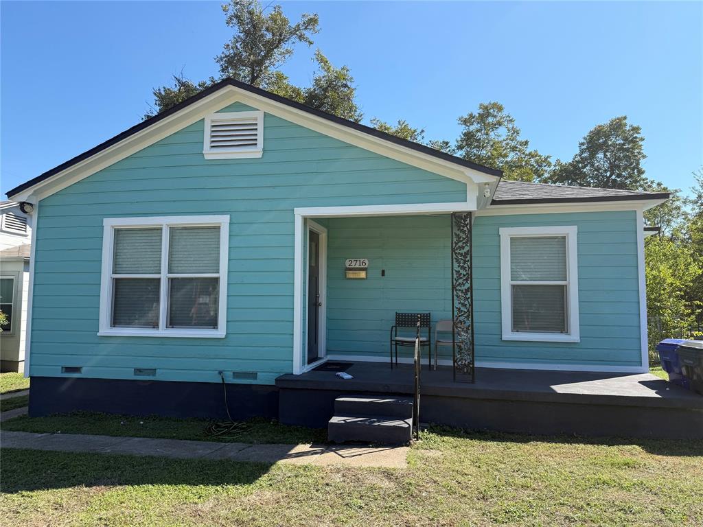 Single-story exterior featuring lap siding, a front porch with decorative wrought-iron support, and a gabled roofline Single-story exterior featuring lap siding, a front porch with decorative wrought-iron support, and a gabled roofline