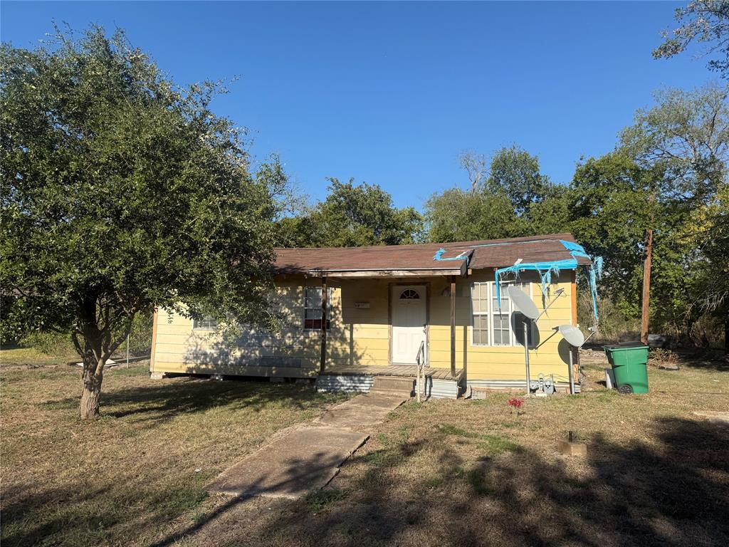 Single-story residence featuring horizontal siding, a covered front porch, and a concrete walkway Single-story residence featuring horizontal siding, a covered front porch, and a concrete walkway