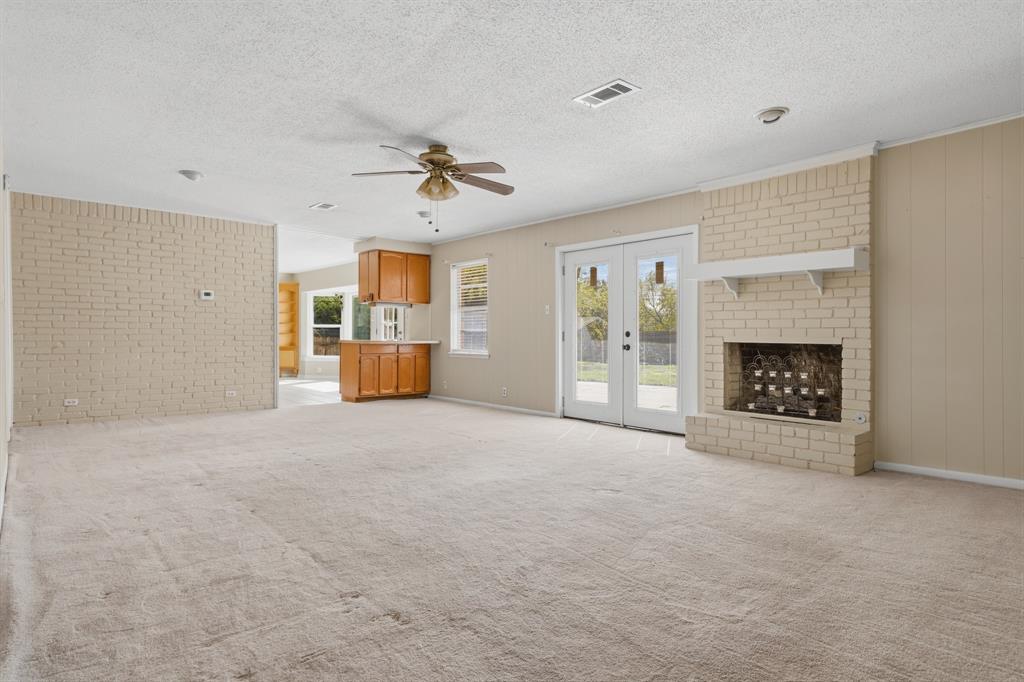 Huge living area with fireplace and double doors to the outside