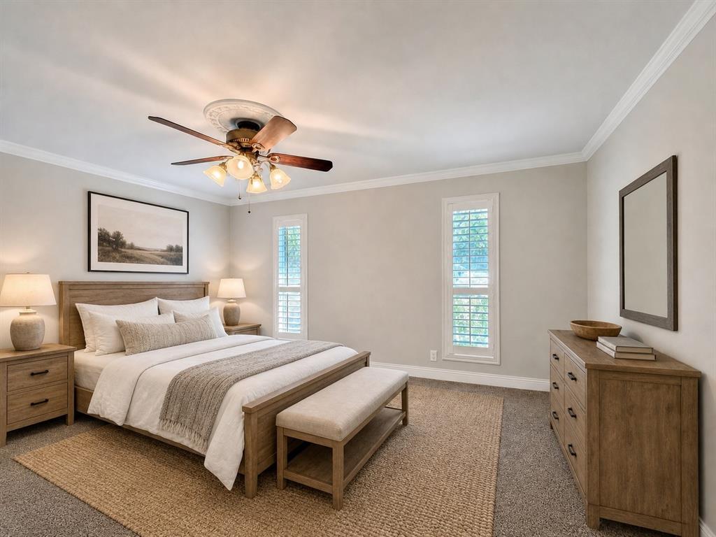 Room featuring crown molding, neutral wall finishes, plantation shutters, and a central ceiling fan with integrated lighting and decorative ceiling medallion