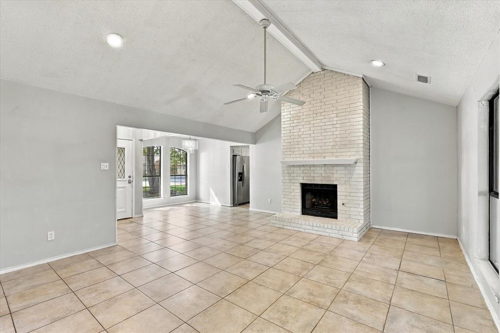 Large spacious family room with vaulted ceilings and fireplace.