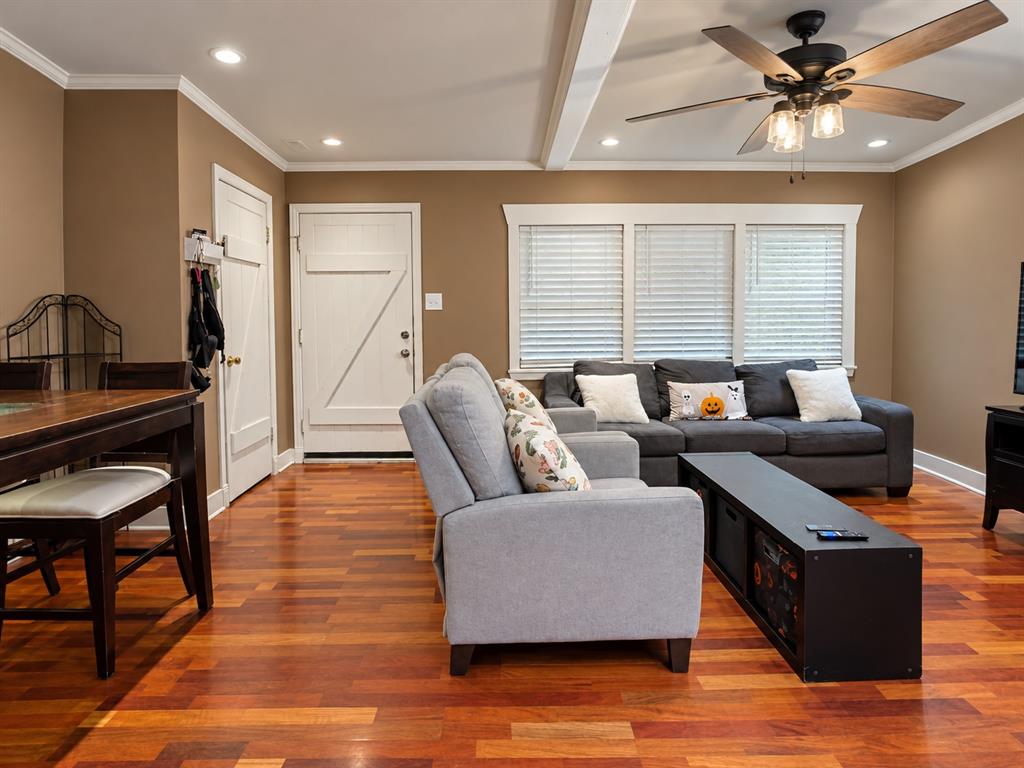 Hardwood flooring, recessed lighting, ceiling fan with integrated light fixture, and three-pane window with horizontal blinds Hardwood flooring, recessed lighting, ceiling fan with integrated light fixture, and three-pane window with horizontal blinds