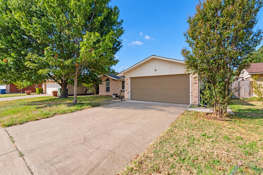 Single-story exterior featuring a brick facade, gabled roofline, two-car garage, and concrete driveway Single-story exterior featuring a brick facade, gabled roofline, two-car garage, and concrete driveway