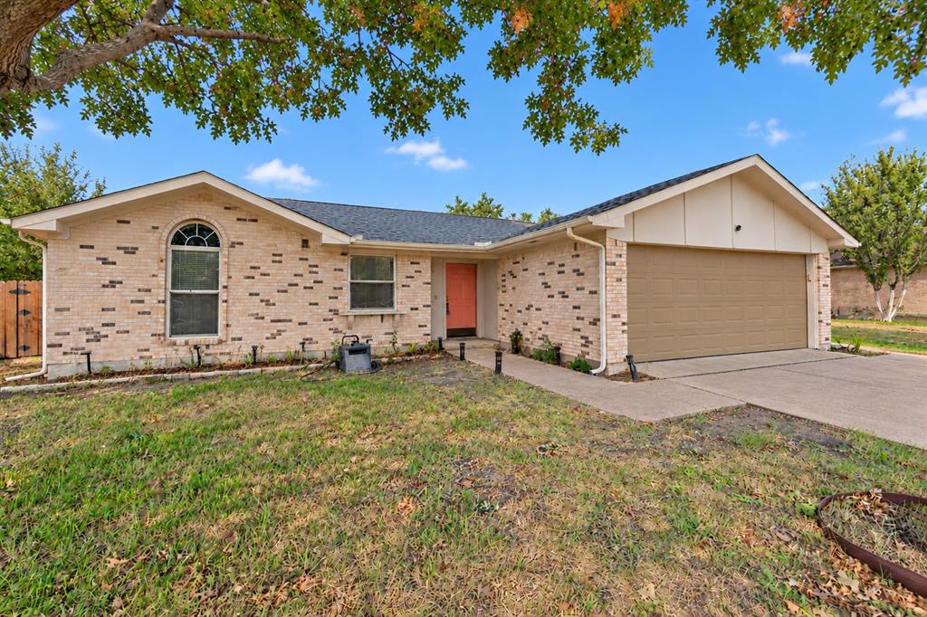 Single-story brick exterior featuring an arched window, asphalt shingle roof, concrete driveway, and attached two-car garage Single-story brick exterior featuring an arched window, asphalt shingle roof, concrete driveway, and attached two-car garage