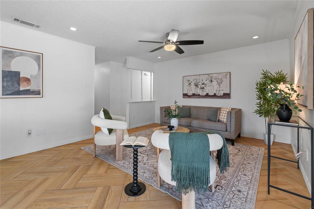Living area featuring herringbone-pattern wood-finish flooring, recessed lighting, and a ceiling fan with integrated light fixture Living area featuring herringbone-pattern wood-finish flooring, recessed lighting, and a ceiling fan with integrated light fixture
