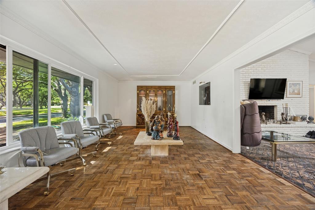 Living Room with inlaid wood floor and large opening to Den. Living Room with inlaid wood floor and large opening to Den.