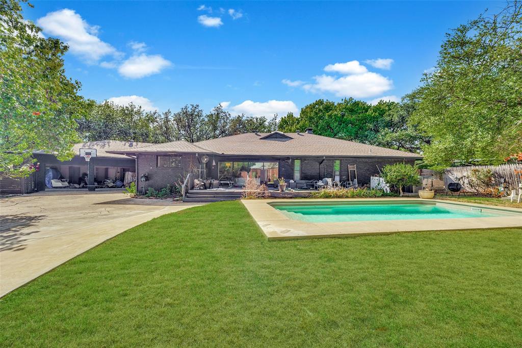 Pool, grassy yard, 3-car garage, and extra parking.